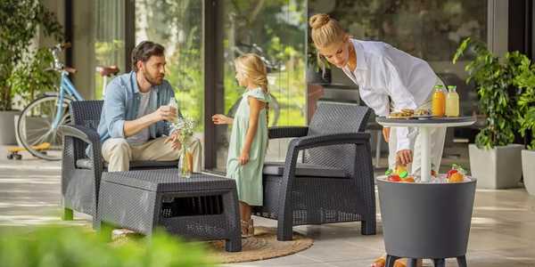 A family having a small garden party and using their Keter cool bar.